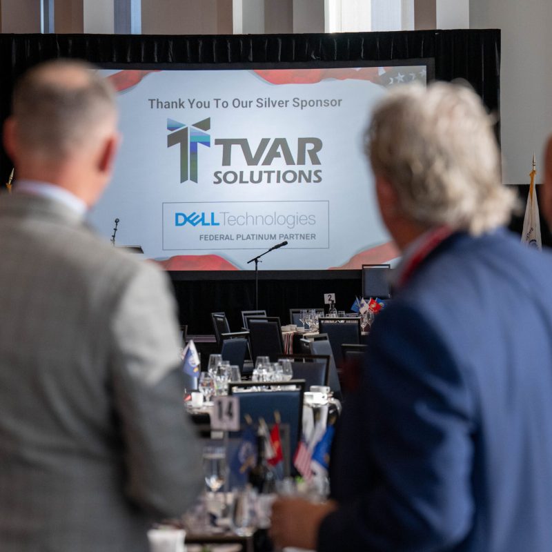 looking at the screen of sponsors